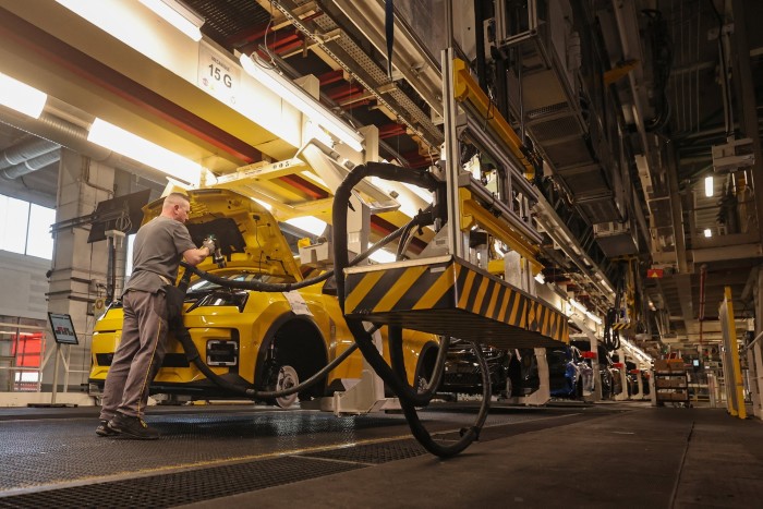 Сотрудник работает на сборочной линии на площадке производства Ampere Electrication Renault Group в Дуаи